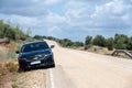 Rus, Spain 29 May 23: A Black Chevy Implala car on a rural road under cloudy sky Royalty Free Stock Photo