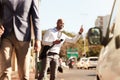 In a rush heading to the office. a handsome young businessman hailing a ride in the city.