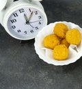 Rush hour eating lunch. cheese ball in a white dish on a stone floor table