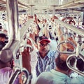 Rush hour in Mumbai local train. Holding tight to the handrails.