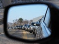 Rush hour traffic jam as viewed from a cars side view mirror