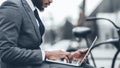 Rush job. Businessman using laptop, sitting on bench in city Royalty Free Stock Photo