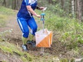 Run people in forest checking chip with control point