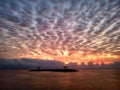 Rushing clouds & dramatic colorful sunrise sky over the sea background. Sanur Beach, Bali, Indonesia