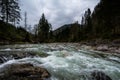 Rushing River over Rocks in Forest with Mountains in Tirol, Austria Royalty Free Stock Photo