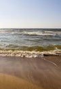 Rushing wave on a sunny day on the sandy beach of the Baltic Sea in Palanga, Lithuania Royalty Free Stock Photo