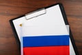 Rusian document, mockup for text on clipboard, white sheet of paper in a folder for notes with flag of russia Royalty Free Stock Photo