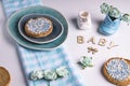 Rusk with blue aniseed balls on blue plate.