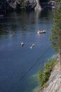 People descend on a trolley over the lake of the Great Marble Canyon in the Republic of Karelia in Russia