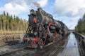 Soviet old steam locomotive L-5164 with the tourist retro train \