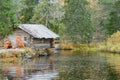 Wooden house by the lake near the waterfall in Ruskeala mountain park