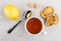 Rusks with raisin, cup of tea, lemon, lumpy sugar