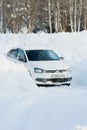 02/16/2022 Russia Agidel, Bashkortostan: A car dug out of a snowdrift after a snowstorm. The car is in the parking lot among piles