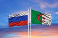 Russia and Algeria flag waving in the wind against white cloudy blue sky together. Diplomacy concept, international relations Royalty Free Stock Photo