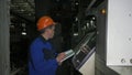 RUSSIA, ANGARSK - JUNE 8, 2018: Operator monitors control panel of production line. Manufacture of plastic water pipes Royalty Free Stock Photo