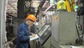 RUSSIA, ANGARSK - JUNE 8, 2018: Operator monitors control panel of production line. Manufacture of plastic water pipes