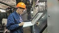 RUSSIA, ANGARSK - JUNE 8, 2018: Operator monitors control panel of production line. Manufacture of plastic water pipes Royalty Free Stock Photo