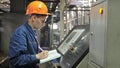 RUSSIA, ANGARSK - JUNE 8, 2018: Operator monitors control panel of production line. Manufacture of plastic water pipes Royalty Free Stock Photo