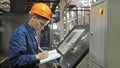 RUSSIA, ANGARSK - JUNE 8, 2018: Operator monitors control panel of production line. Manufacture of plastic water pipes Royalty Free Stock Photo