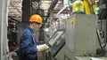 RUSSIA, ANGARSK - JUNE 8, 2018: Operator monitors control panel of production line. Manufacture of plastic water pipes Royalty Free Stock Photo