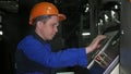 RUSSIA, ANGARSK - JUNE 8, 2018: Operator monitors control panel of production line. Manufacture of plastic water pipes Royalty Free Stock Photo