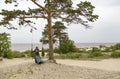 On the coast of the White Sea, a girl swinging on a swing. Royalty Free Stock Photo