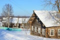 Russia, Arkhangelsk region, wooden buildings in the village Turchasovo in winter in sunny weather Royalty Free Stock Photo