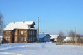 Russia, Arkhangelsk region, wooden buildings in the village Turchasovo in winter in sunny weather Royalty Free Stock Photo