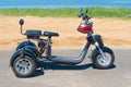 Russia, Bolgar - June 08, 2019 Kol Gali Resort Spa: Three-wheeled electric motorcycle on the beach. Walk on a electric scooter in