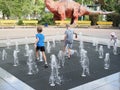 Russia, Boronezh region - august,2020: Toddler playing with small fountains on the urban plaza