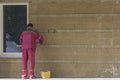 Russia, Bryansk-07/23/2018: a worker plasters the wall of a building