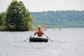 Russia, Cheboksary - July 13, 2014: Happy sporty man sailing on the boat.