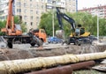 Russia, Chelyabinsk 08/02/2020, Auto crane and bulbdozer are replacing old worn pipes of heating networks in the municipal economy