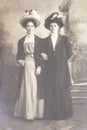 RUSSIA - CIRCA 1905-1910: Full body shot of two young women in studio, Vintage Carte de Viste Edwardian era photo Royalty Free Stock Photo