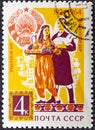 RUSSIA - CIRCA 1964: stamp printed by Russia, shows Uzbek Farm Couple and Arms, circa 1964.