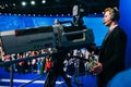 Russia, city Moscow - December 18, 2017: A professional cameraman shoots a crowd of people on the studio camera. High