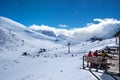 Russia, Dombai-February 7, 2017: Beautiful view of Ski resort high in the mountain. Group Of Friends Enjoying Hot Drink