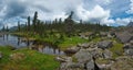 A quiet lake among rocks and dense taiga Royalty Free Stock Photo