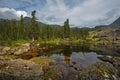 A quiet lake among rocks and dense taiga Royalty Free Stock Photo