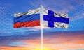 Russia and Finland flag waving in the wind against white cloudy blue sky together Royalty Free Stock Photo