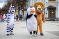 Animators in a penguin, lion and zebra costume from Madagascar in the city