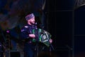 Russia, Gelendzhik, May 01, 2019: A man wearing as cossack plays an accordion and sing a folk song