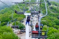 Russia, Gelendzhik, May 02, 2019: A worker performs maintenance on a cable car rack with open chairs