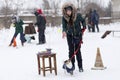 The girl is coached by Jack Russell on the street in winter,