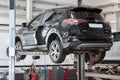 Russia, Izhevsk - April 21, 2018: Automobile workshop. Replacement and wheel alignment on a hydraulic lift. Royalty Free Stock Photo