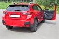 Russia, Izhevsk - August 13, 2020: New modern Subaru XV car with open door passenger. Back and sive view