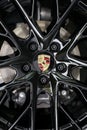 Russia, Izhevsk - August 04, 2020: Porsche showroom. The black alloy wheel of a new Panamera 4 car. Cropped image
