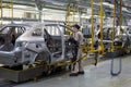 Russia, Izhevsk - December 14, 2019: LADA Automobile Plant Izhevsk. The workers put doors on the body of a new car.