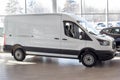 Russia, Izhevsk - February 17, 2021: Ford showroom. New Transit van in the dealer showroom. Side view. Famous world brand Royalty Free Stock Photo