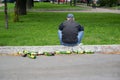 RUSSIA. Drunk man sits on sidewalk curb in park